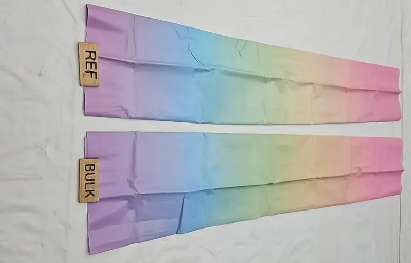 Two pastel rainbow-gradient sheets laid flat, labelled REF and BULK, for a colour comparison.