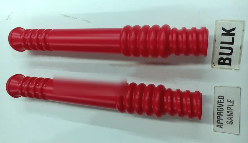 Two red ribbed plastic handles side by side, tagged BULK and APPROVED SAMPLE.